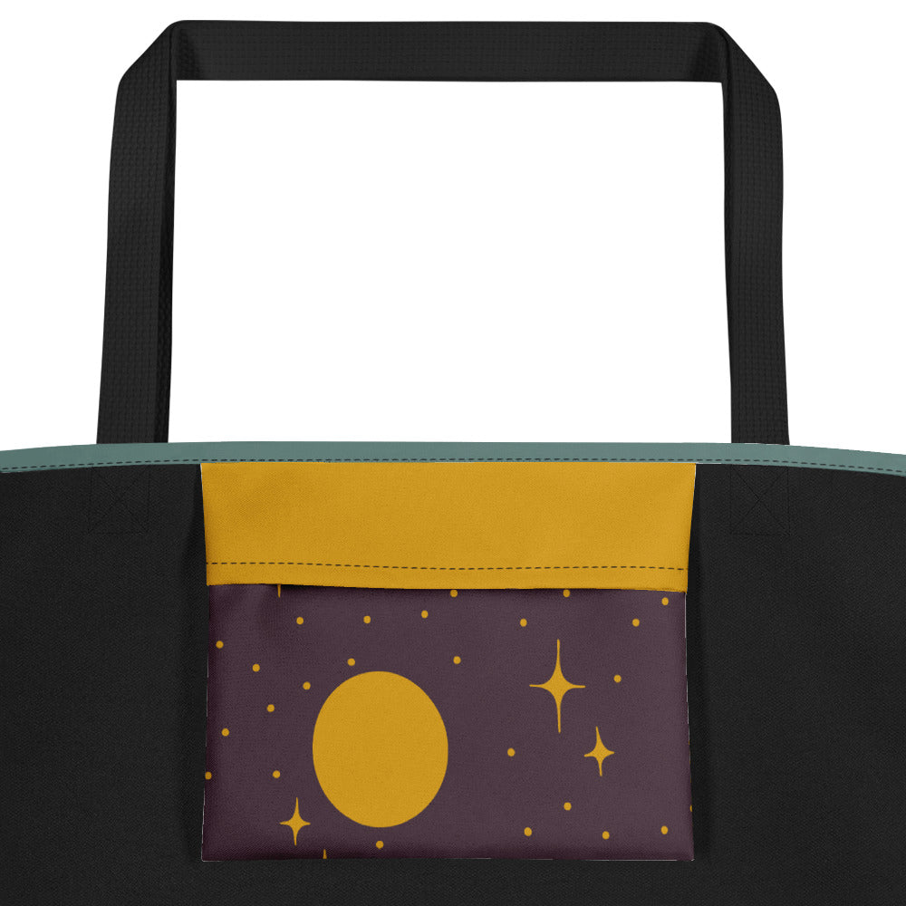 Closeup of inside pocket of a tote bag with a moon and stars on it.