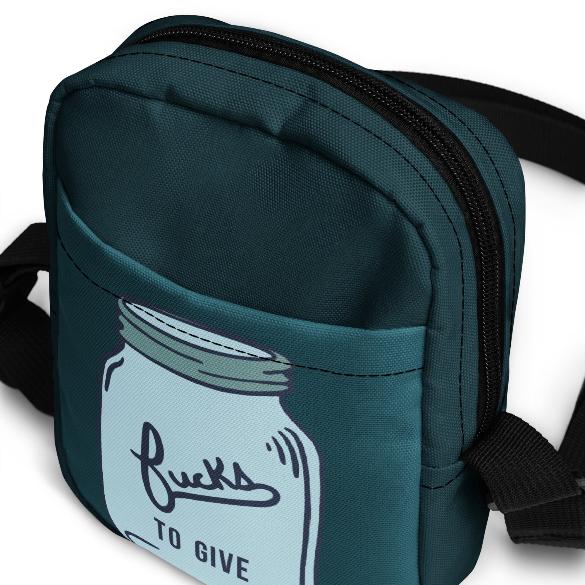 Top view of a crossbody bag with a mason jar that says fucks to give and is empty