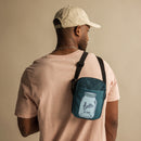 Black man with a crossbody bag over his shoulder